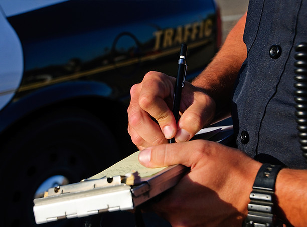 Traffic school instructor writing a citation